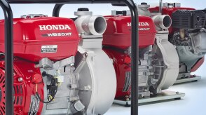Three Honda pumps are displayed side-by-side in a nondescript environment. 